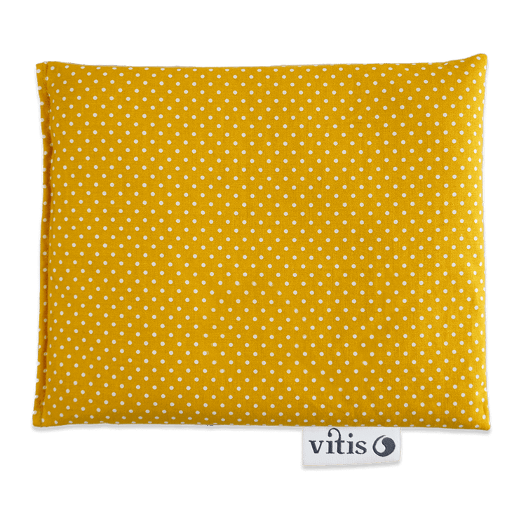 Ein maisgelbes Traubenkernkissen mit weißen Punkten von der Firma Vitis Traubenkern GmbH.