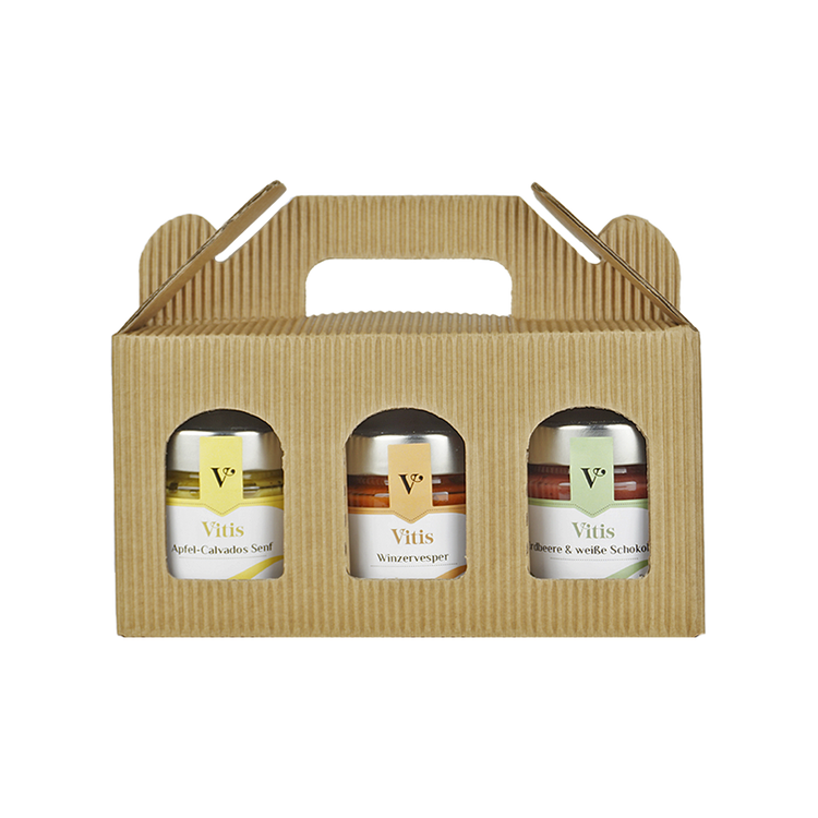eine Geschenkbox mit den Feinkost Spezialitäten Apfel-Calvados Senf, Winzervesper Brotaufstrich und Erdbeere mit Prosecco Fruchtaufstrich der Firma Vitis Traubenkern GmbH